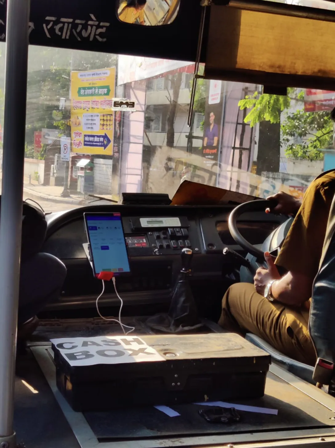 Android tablet ETM installed at driver's seat with integrated cash box — conductorless bus operation