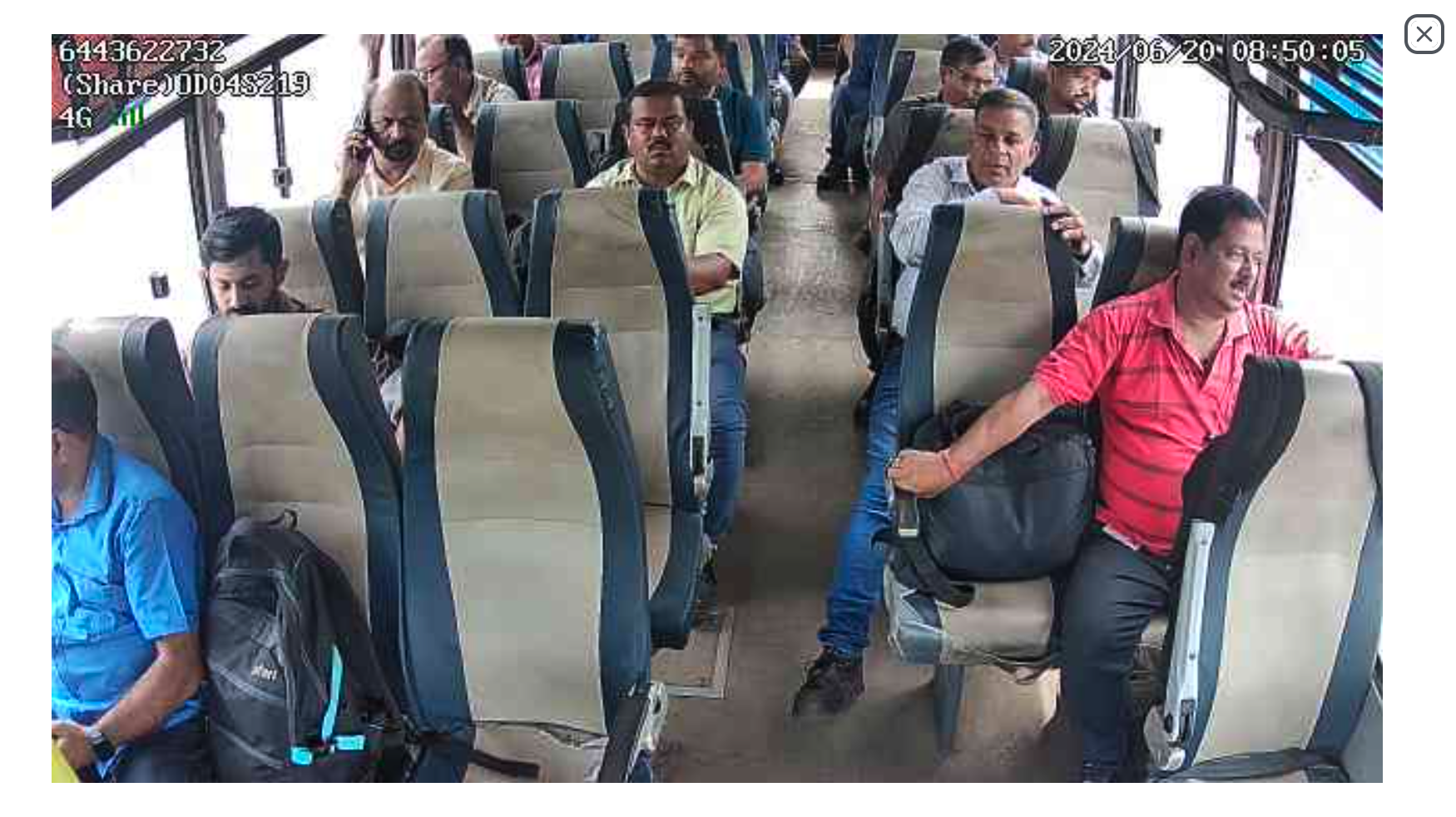 Back camera CCTV view — rear of bus with passengers
