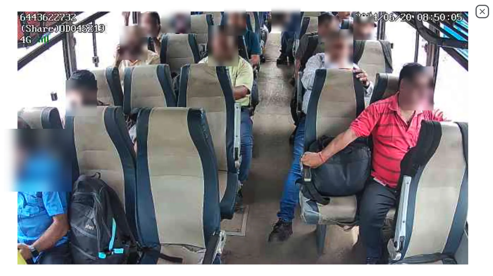 Back camera CCTV view — rear of bus with passengers