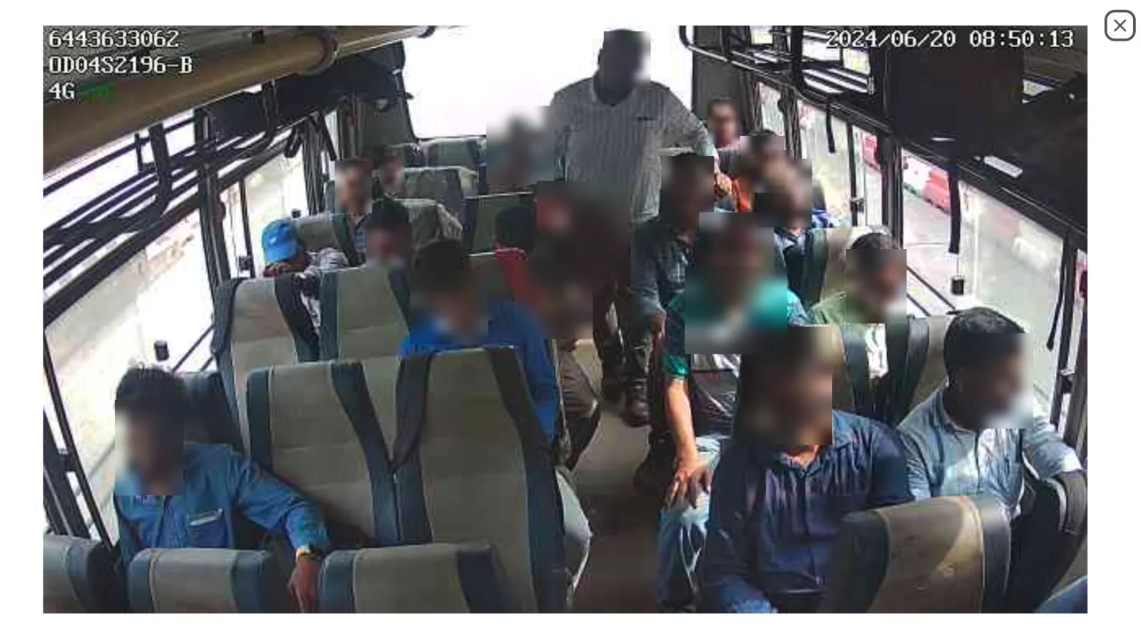 Front camera CCTV view — passengers seated on bus